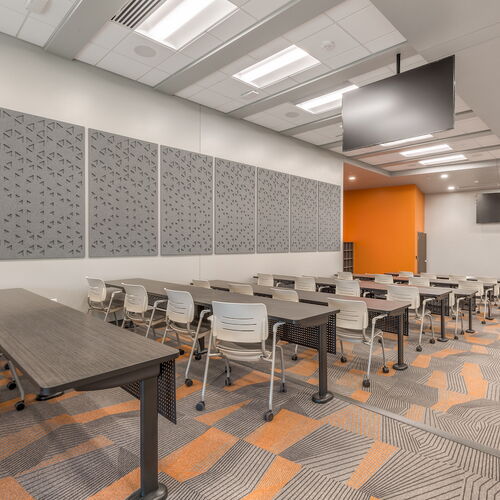 Modern Classroom Interior with Gray Tables, Chairs and Decorative Wall Panels