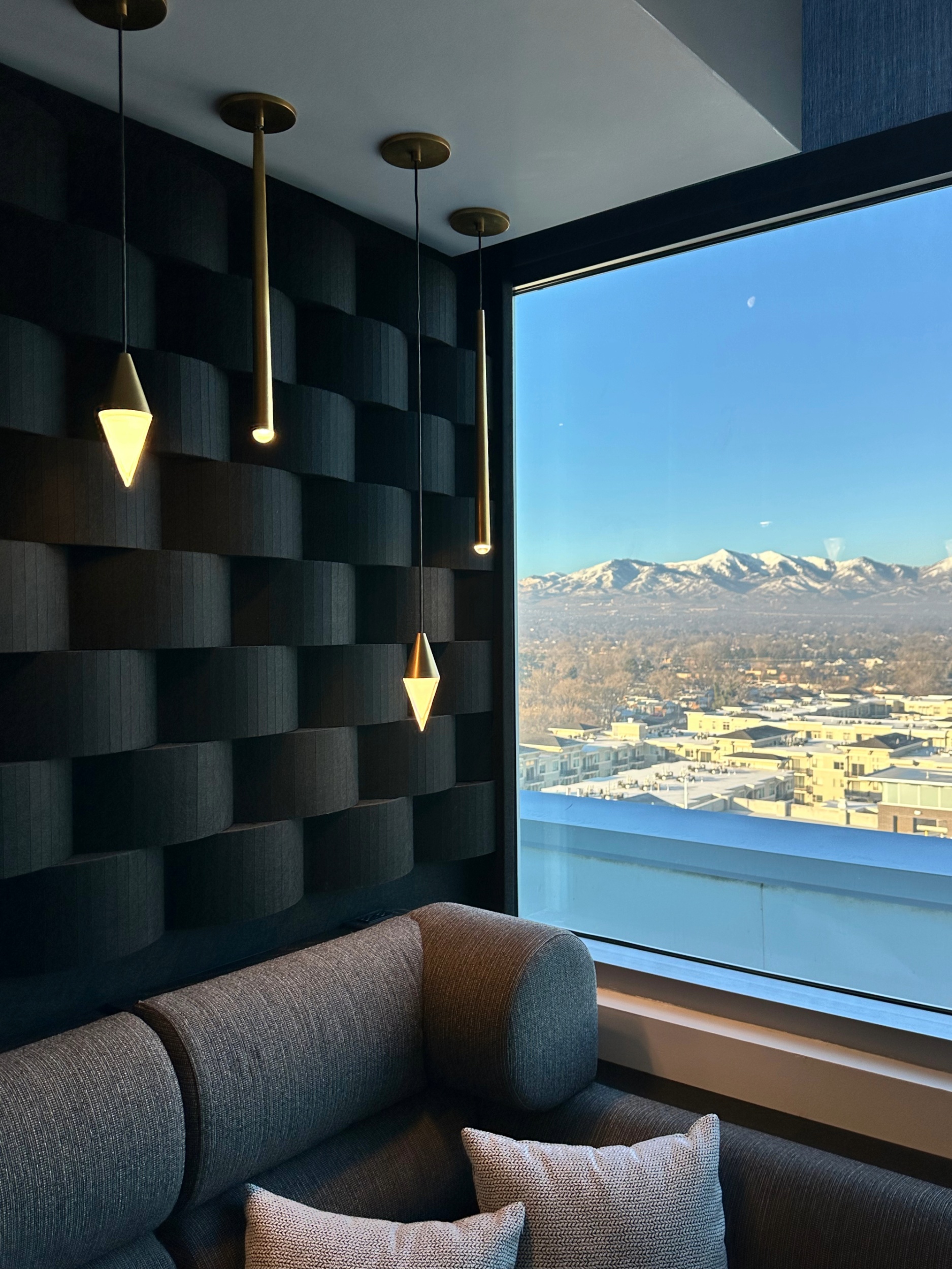 Modern Room Interior with Stylish Pendant Lights and a View of Snow-Capped Mountains