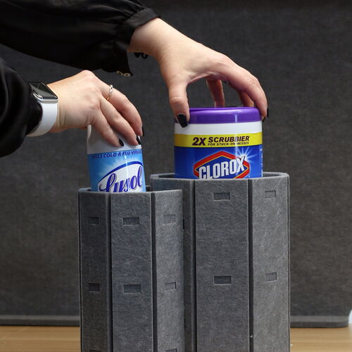 Hands Placing Disinfectant Wipes on a Modern Gray Structure