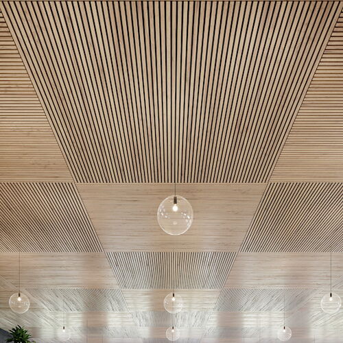 Modern wooden ceiling with linear patterns and hanging pendant lights, enhancing interior aesthetics.