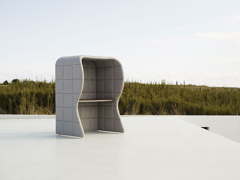 Modern Outdoor Quilted Chair Positioned on a Sleek Surface Against a Natural Backdrop