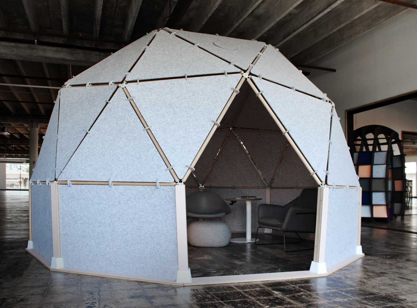 Geodesic Dome with Modern Furnishings Inside an Industrial Space