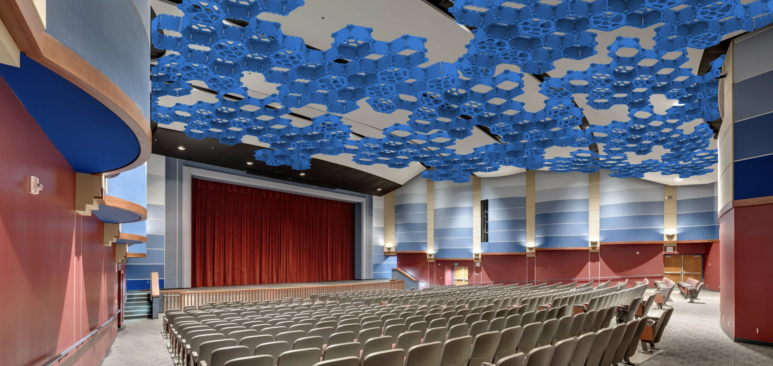 Interior of a Modern Auditorium with Blue Decorative Ceiling and Red Curtains